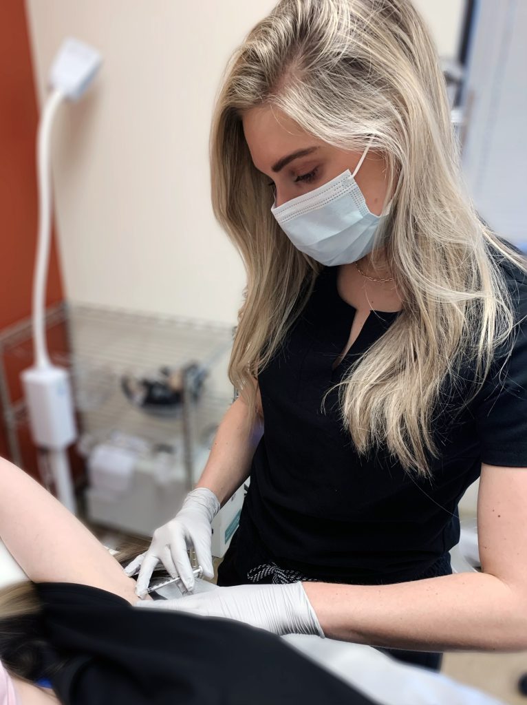 elizabeth russeau administering skin treatment